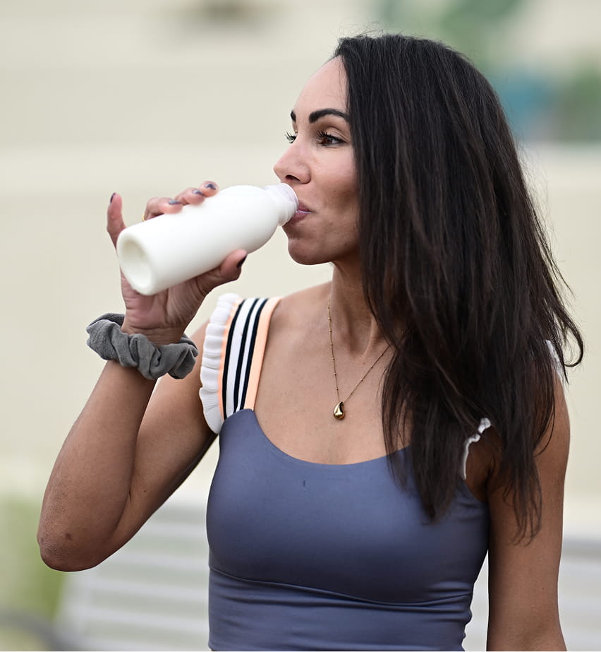 Woman drinking milk from a bottle.